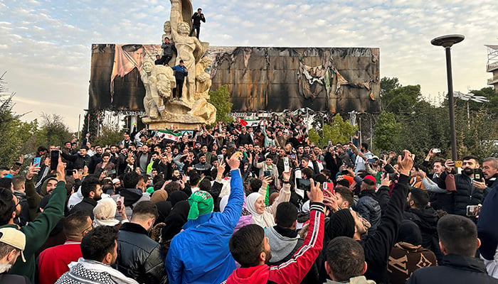 People gather at Saadallah al-Jabiri Square as they celebrate, after Syrias army command notified officers on Sunday that President Bashar al-Assads 24-year authoritarian rule has ended. — Reuters