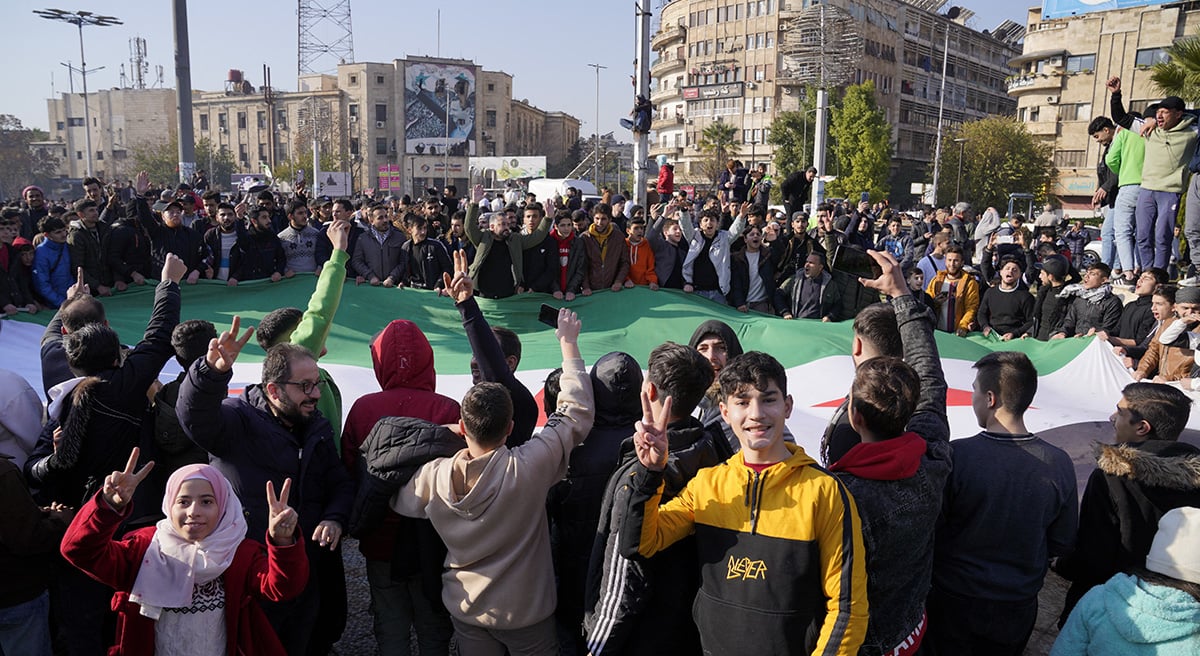 People hold the Syrian opposition flag as they celebrate, after Syrias army command notified officers on Sunday that President Bashar al-Assads 24-year authoritarian rule has ended, in Aleppo, Syria December 8, 2024. — Reuters