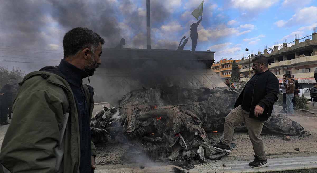 Syrian Kurds destroy the statue of Basel al-Assad, the late elder brother of Syrias President Bashar al-Assad as they celebrate the fall of capital Damascus to anti-government fighters, in the city of Qamishli on December 8, 2024.