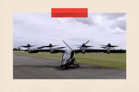 An aircraft with propellers rests on a paved path. Behind it is grass and an overcast sky.