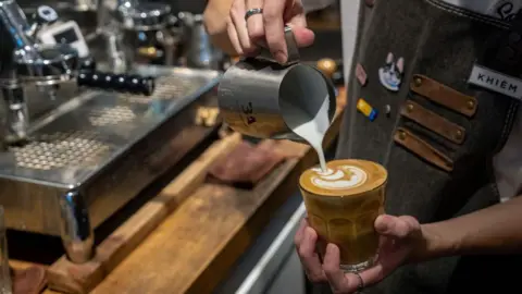 Getty Images A barista prepares a cup of coffee at a shop in Hanoi, Vietnam, on Tuesday, 30 August, 2022. 