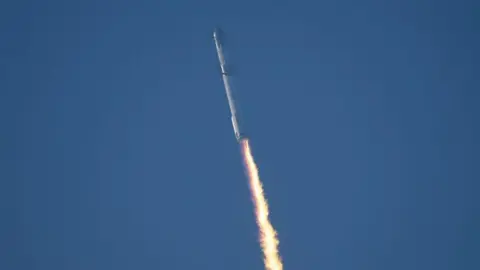 Getty Images Starship rocket launching into space with trail of fuel behind it